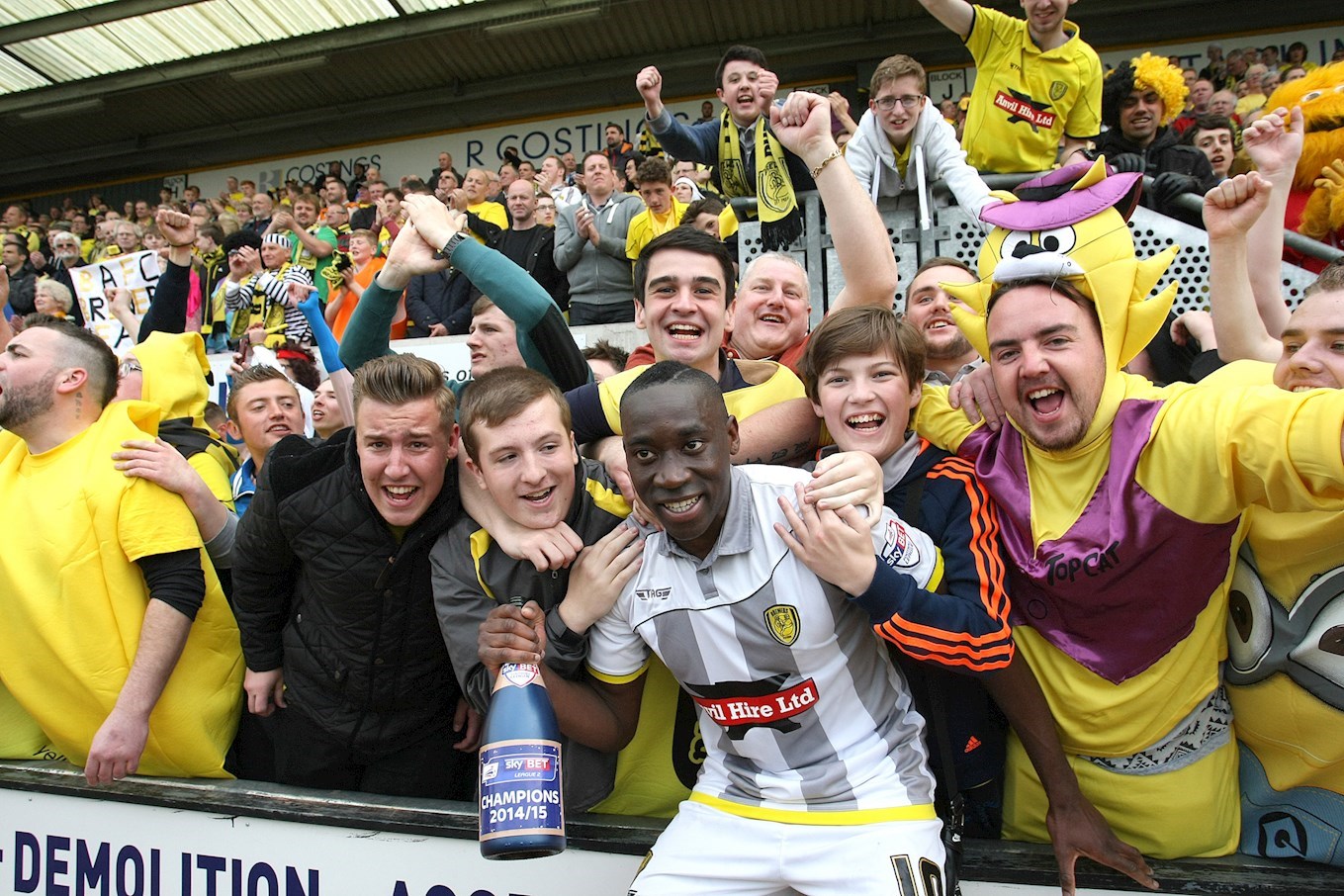Lucas Akins celebrates winning the Sky Bet League Two title at Cambridge United in May 2015